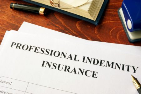 a professional indemnity insurance policy on a desk